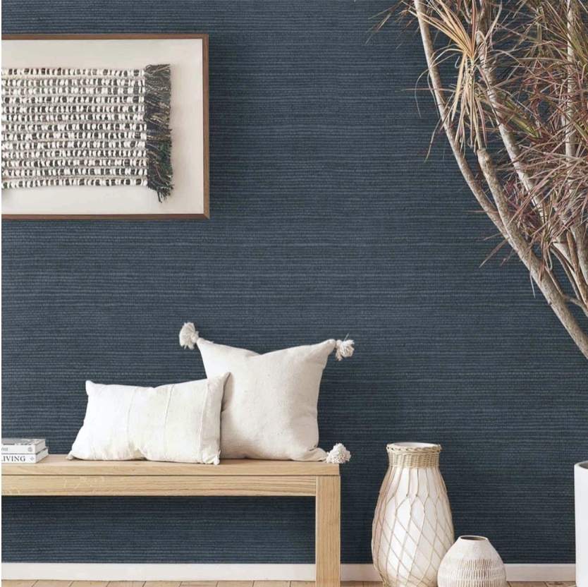 decorative bench and pillows on navy blue wall
