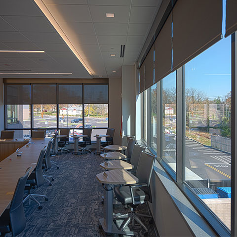 Classroom interior with recessed lighting and automatic shades