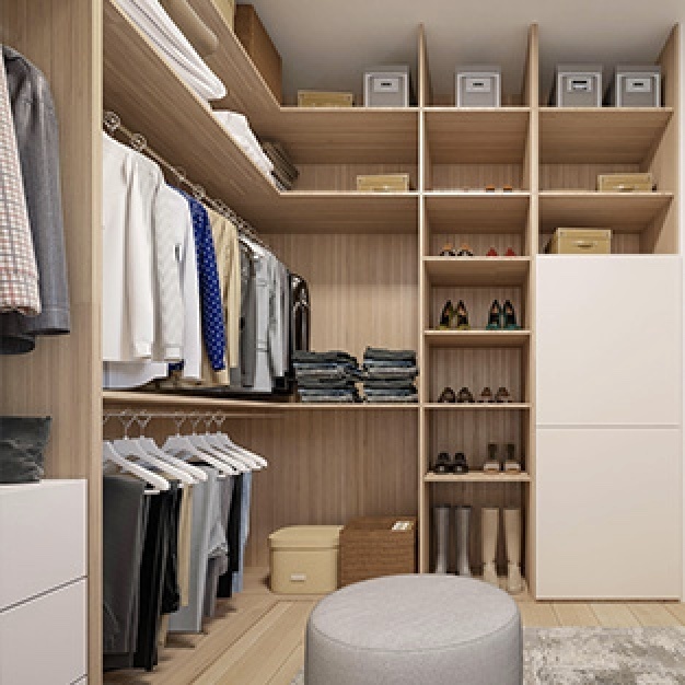 walk in closet with hanging clothes, shelving, hanging pants, and stool