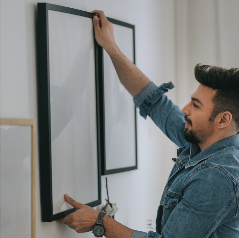person hanging frame