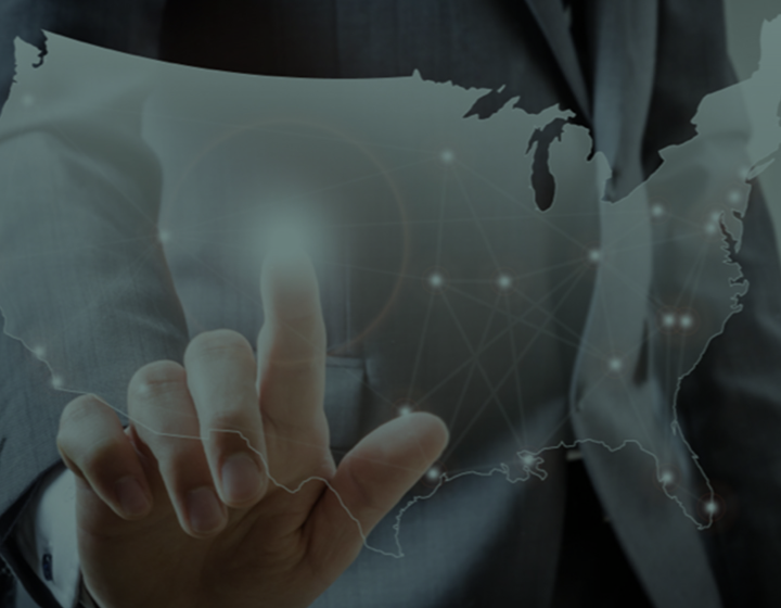 Hand pointing to translucent map with light radiating from touchpoint