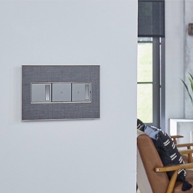 grey light switch on wall outside livingroom